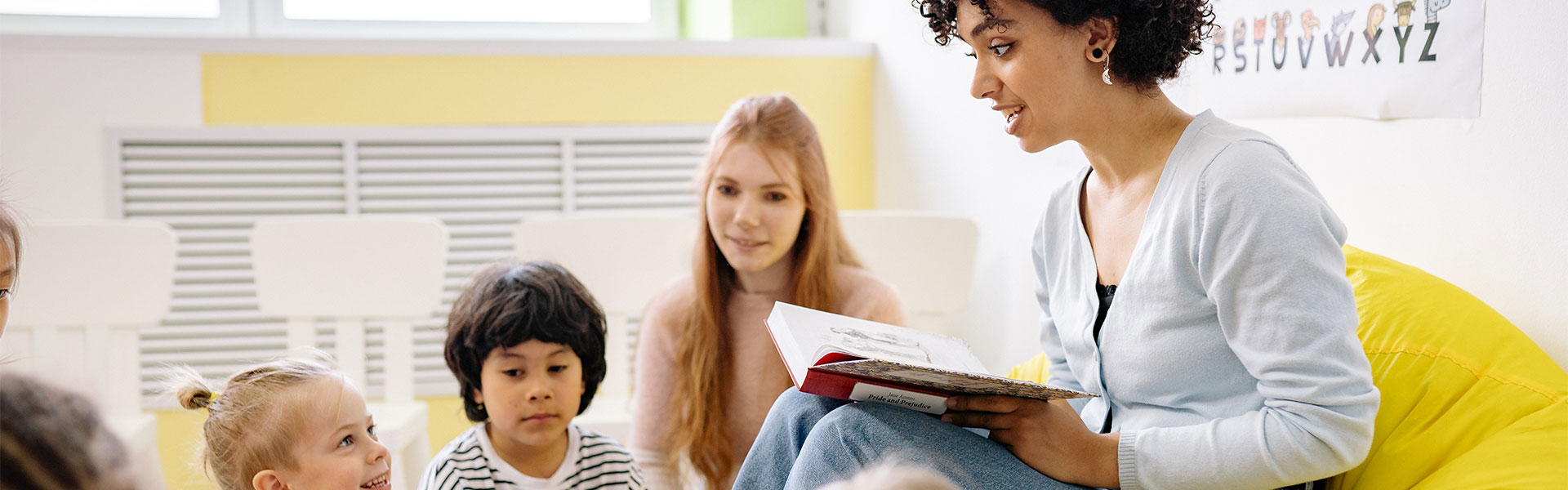Woman reading Pride and Prejudice to kids